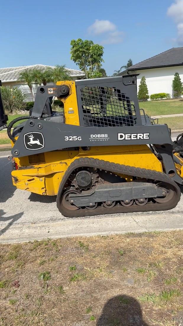 Compact loader used for land clearing and debris work